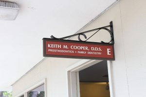 Keith M. Cooper, DDS Prosthodontics, Family Dentistry sign hanging outside office door
