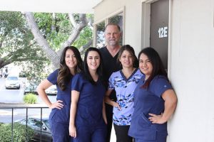 Dr. Cooper with members of the Contemporary Dental Arts team outside their office